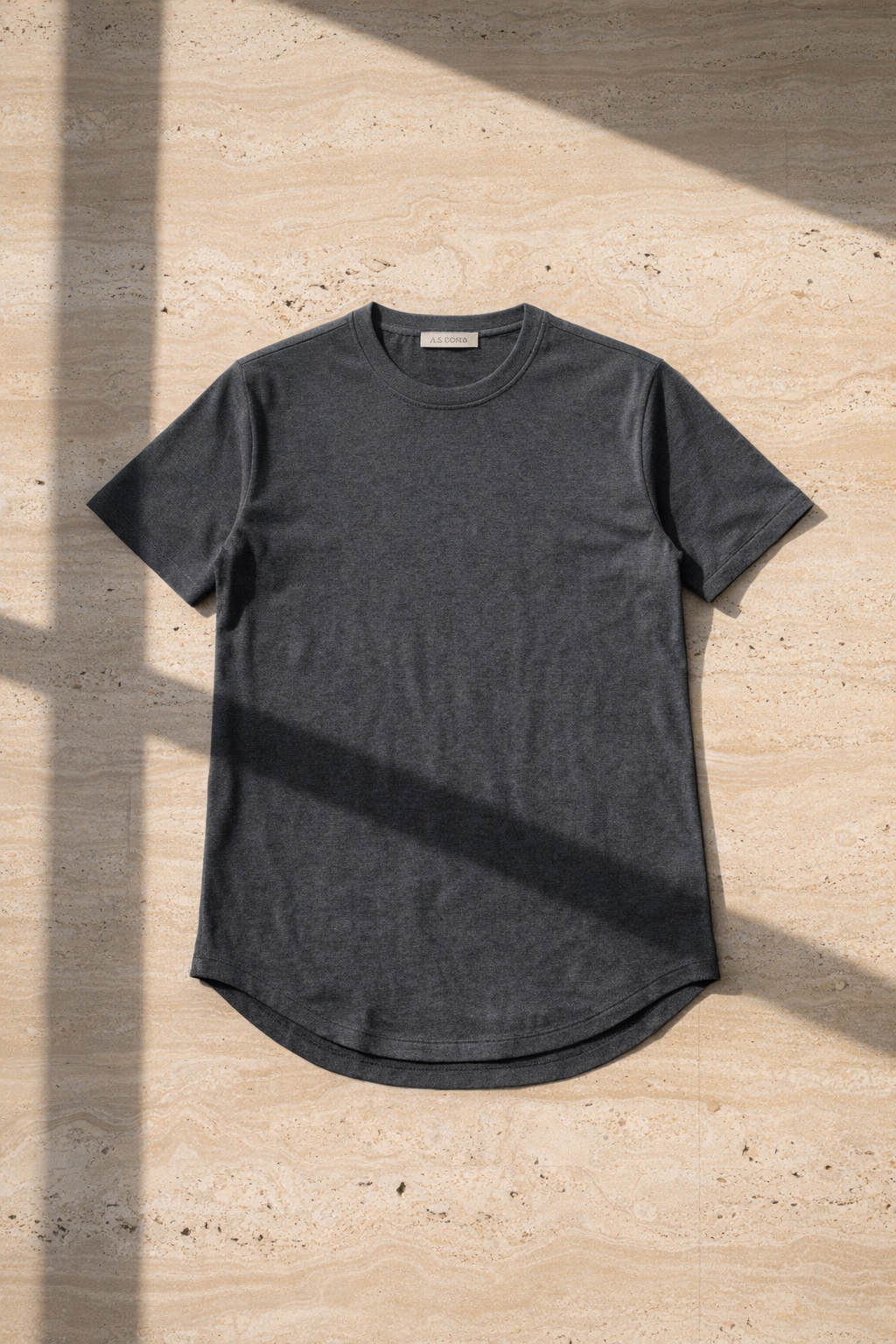 Charcoal t-shirt on a textured beige surface